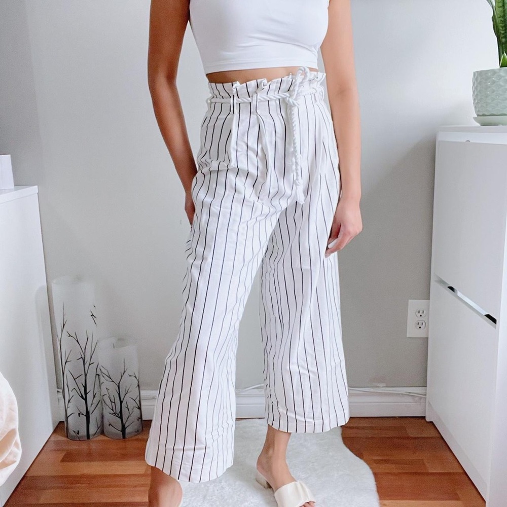 White wide leg pants with vertical line prints.
